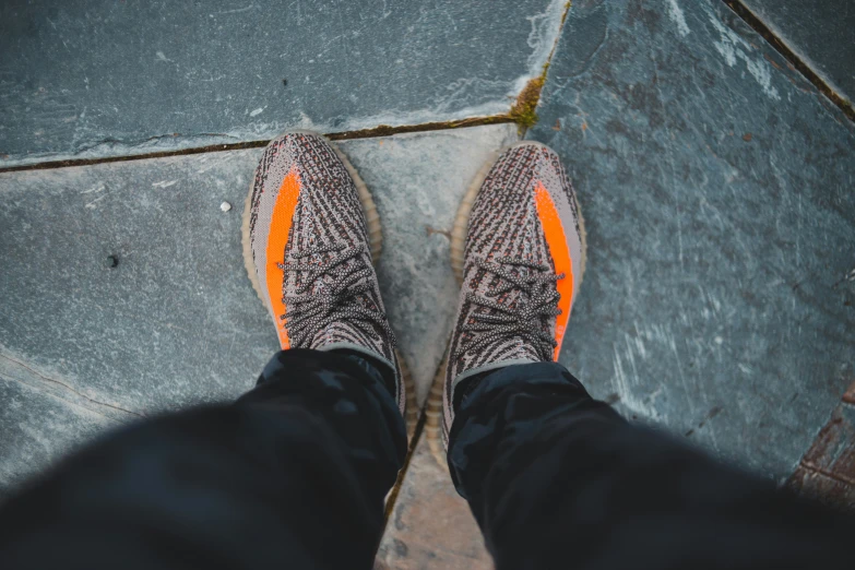 a person wearing a pair of black pants and orange socks