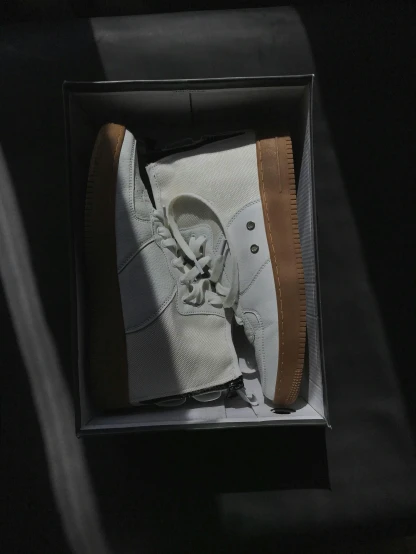 an image of a white sneakers that are in the box