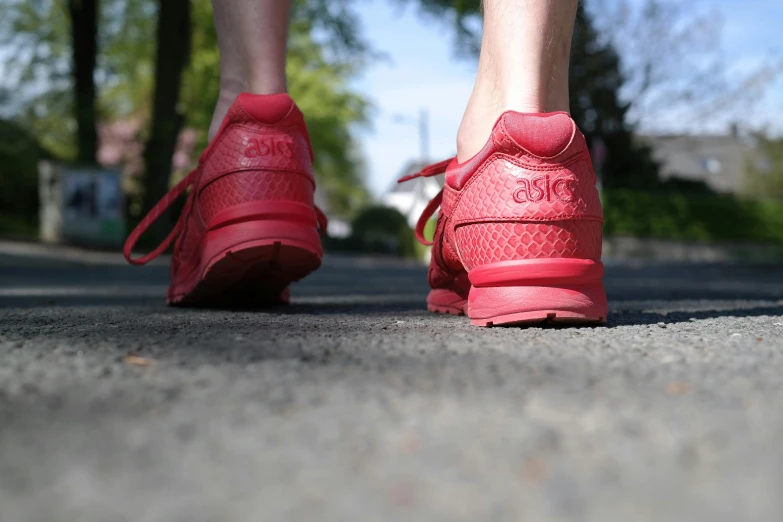 feet with red shoes and an upper part of the legs