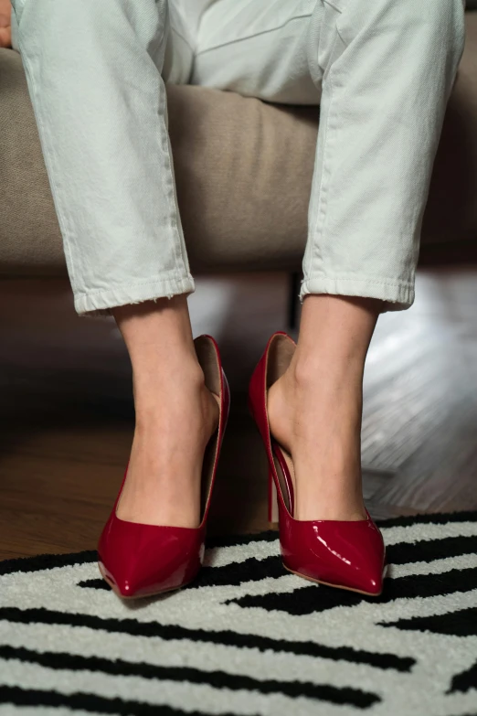 a close up view of a woman's feet wearing high heel red shoes