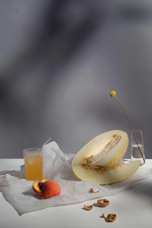 peeled melon, orange juice, and walnuts on a table