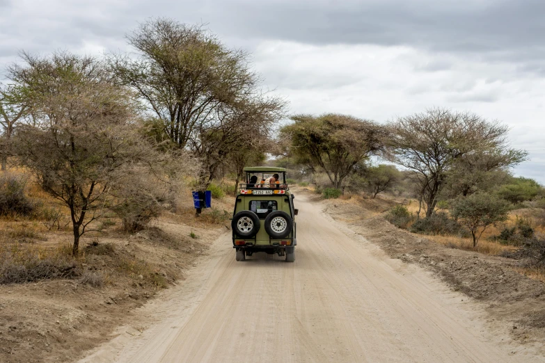 an off road vehicle with two people walking on the side