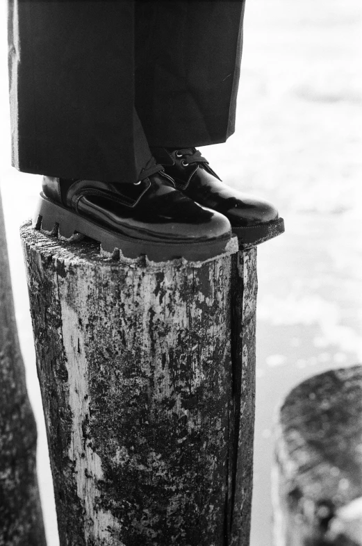 black and white pograph of shoes on pole