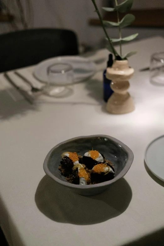 a table set with glasses and plates of food