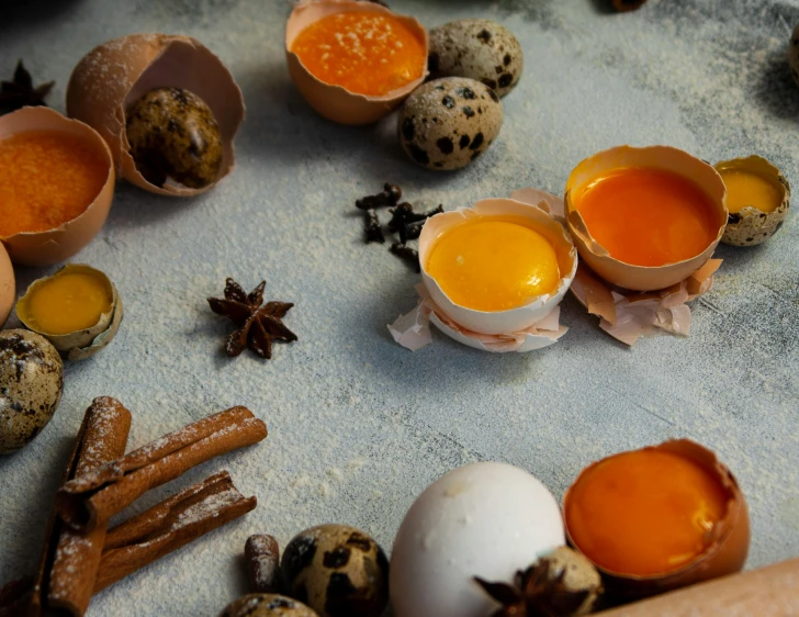 an assortment of eggs, spices and other ingredients are arranged on a table