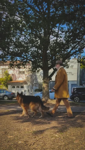a man walking with a dog in the park