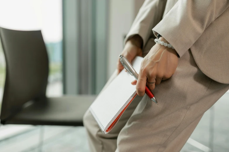 a man holding a clipboard and pen in his hand