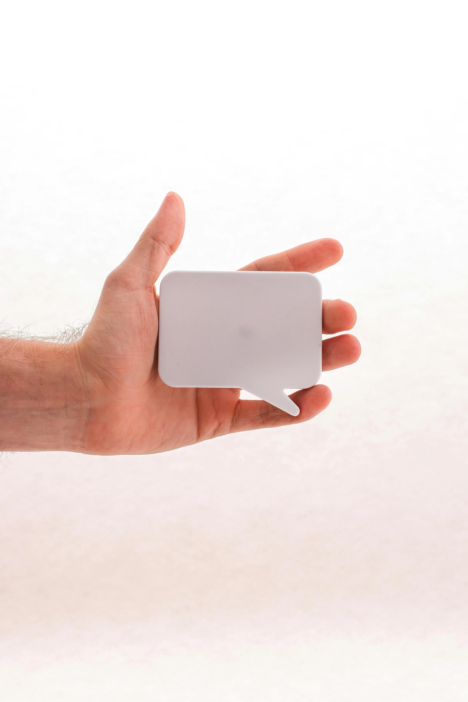 hand holding an external device with small white cube