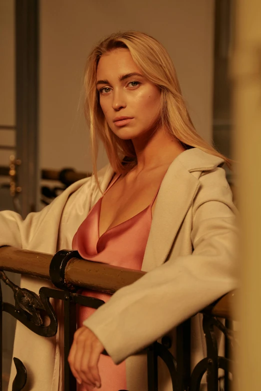 a beautiful young woman sitting on top of a balcony