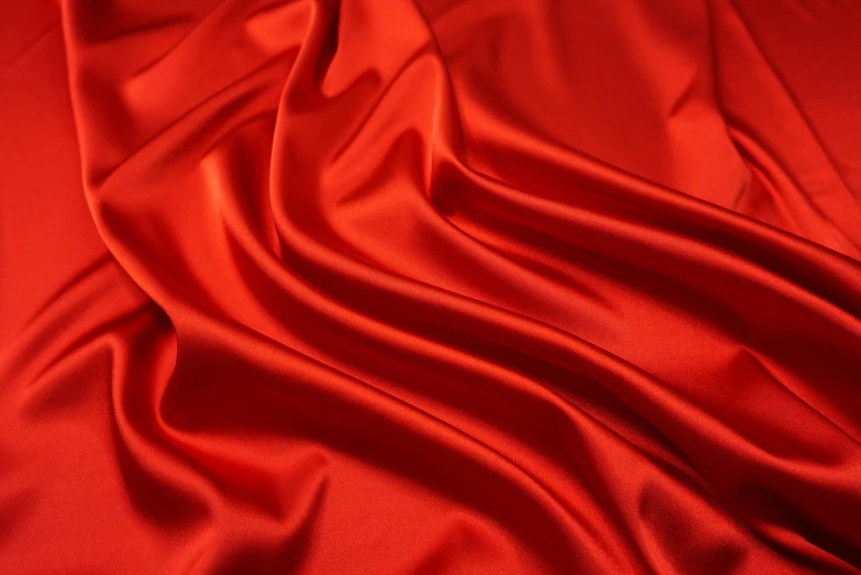 a red satin plain fabric with folds