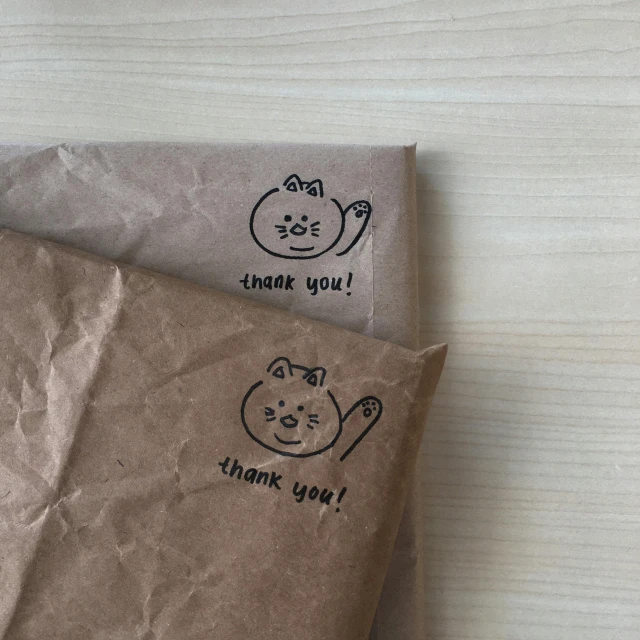 two envelopes with cat designs on them, one has a note for thank you