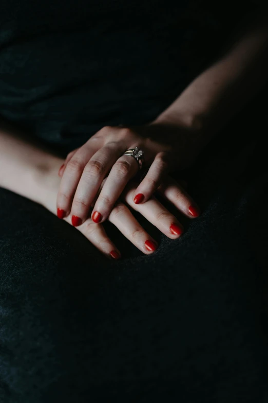 hands wearing an engagement ring holding onto a pillow