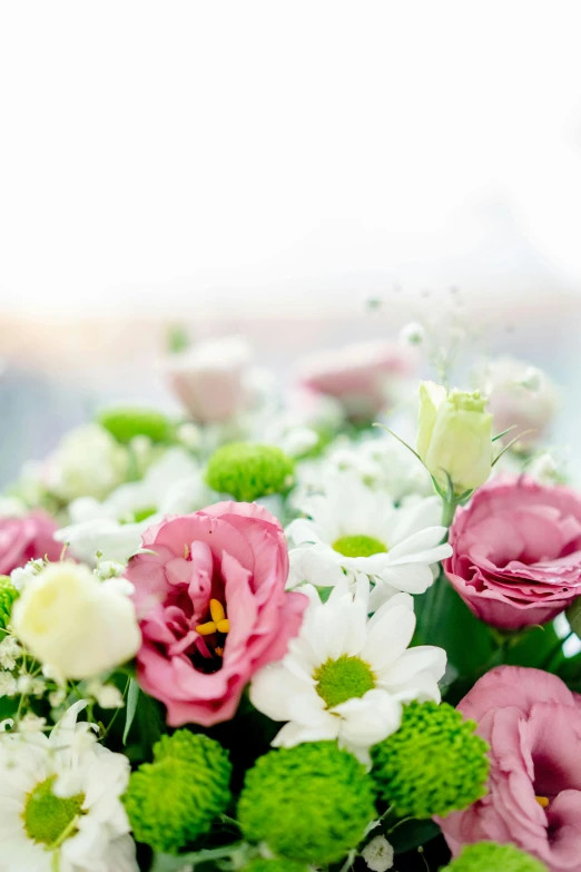 a pile of white and green flowers sitting on top of a table