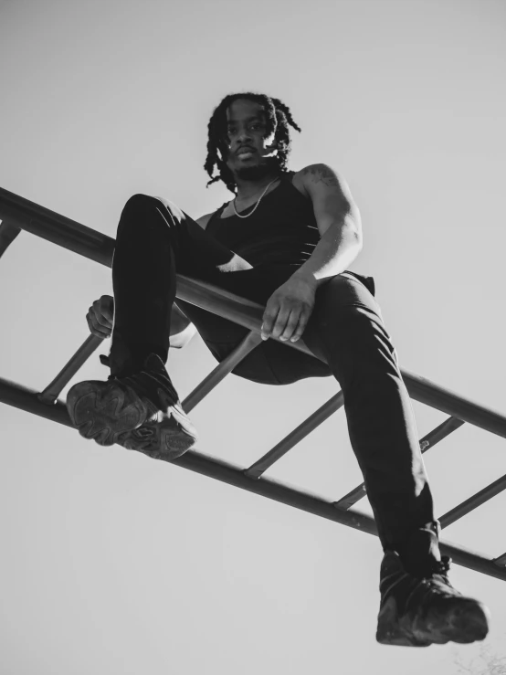 a man is sitting on the top of a building