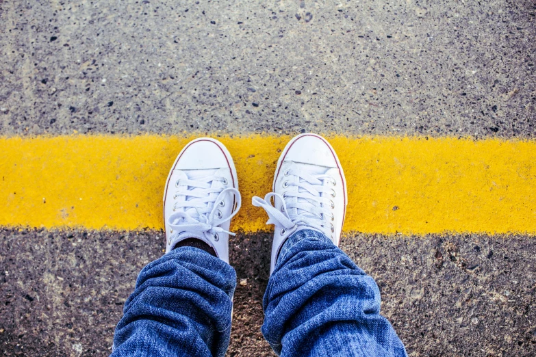 someone standing on the street with their shoes on