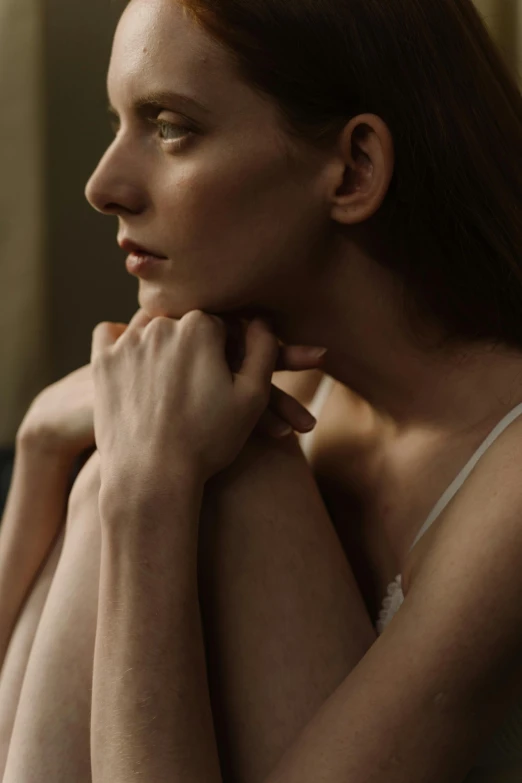 a woman in white top sitting on a chair