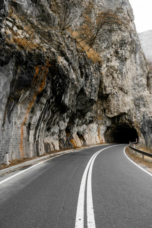 the winding road is dotted with large, sharp white lines