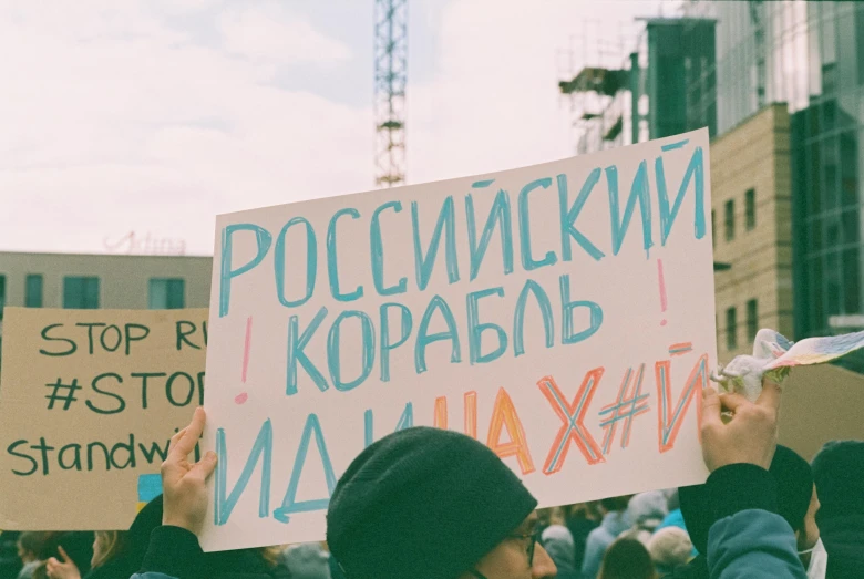 people with signs and building in the background