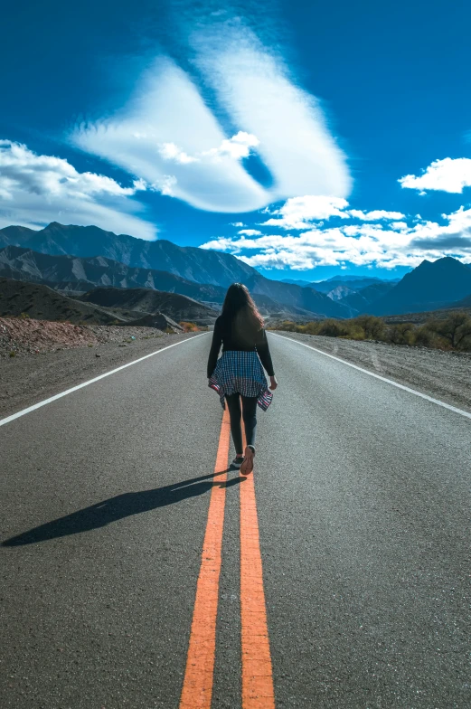 a person standing on the side of the road in the middle of nowhere