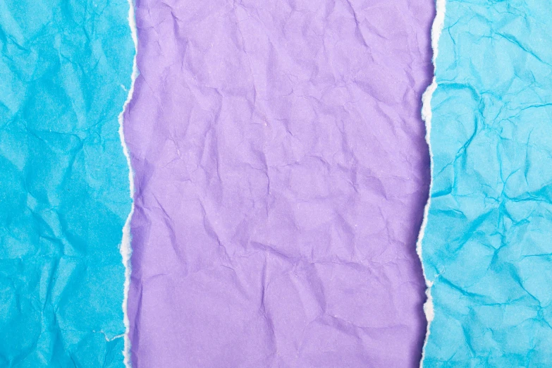 blue and purple paper torn in half on top of each other