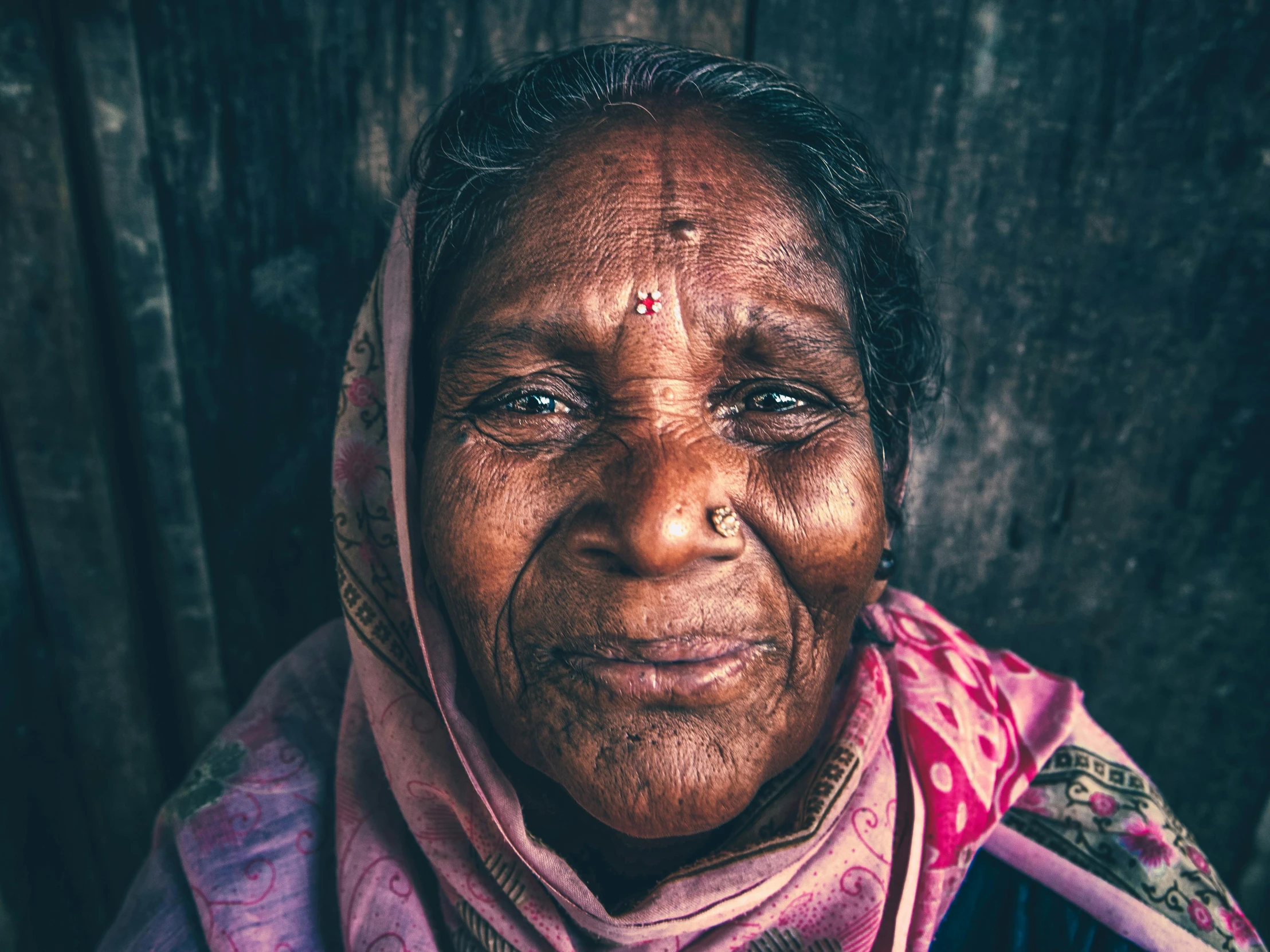 an older woman with red eyes stares at the camera