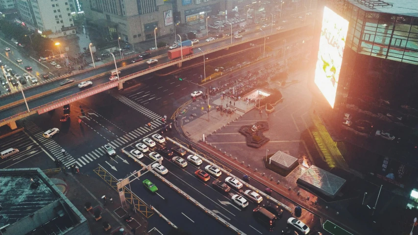 an overhead view shows street traffic and billboards