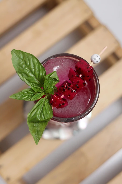 a purple and red drink is shown with leaves