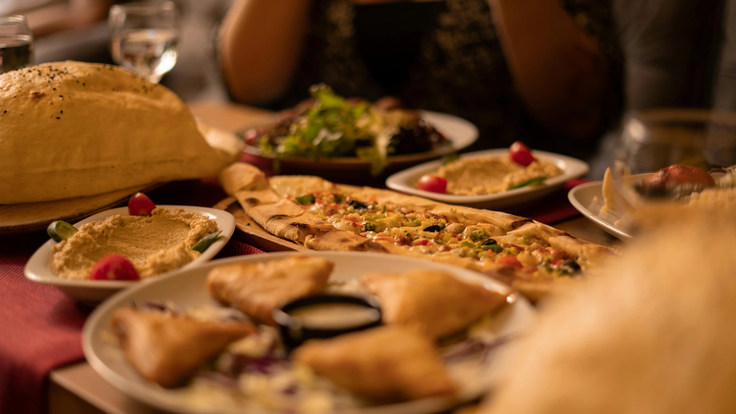 plates with food on them and people eating at a table