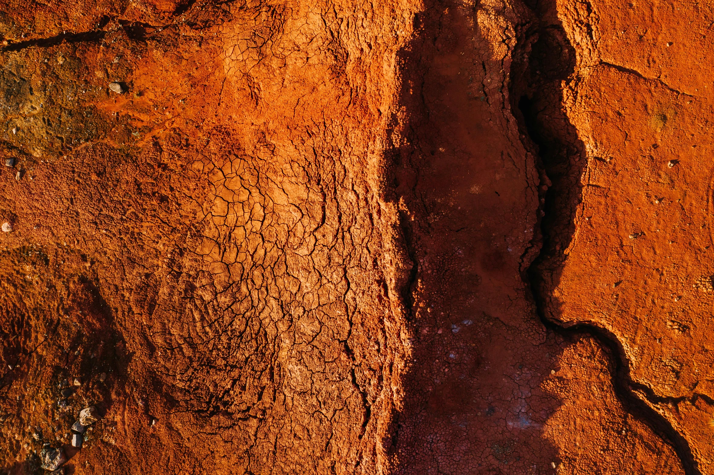 an aerial view of orange rock formations in a desert