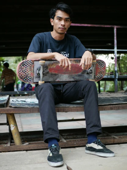 a person holding a skateboard up on a bench