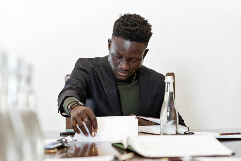 a man sitting at a table with an open book