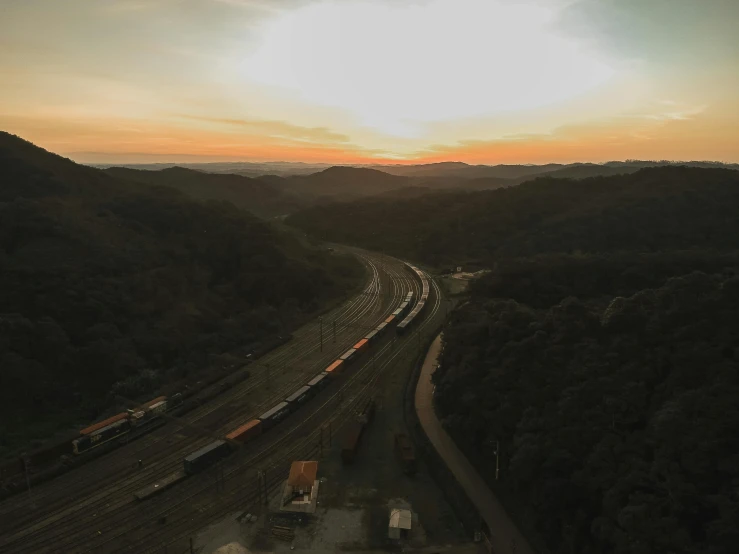 aerial view of a train running through a forested area