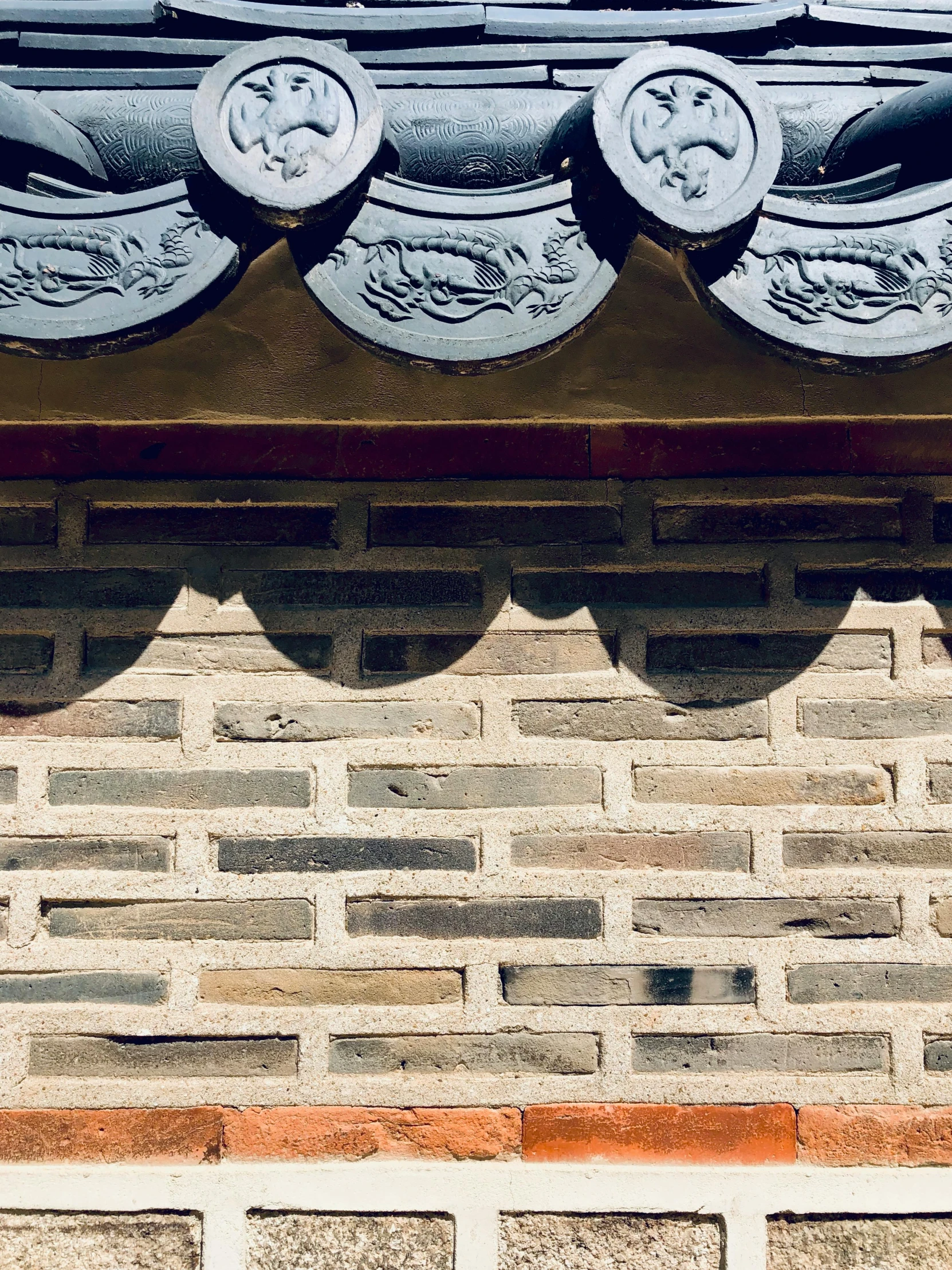 a small ornate roof design on an old brick building