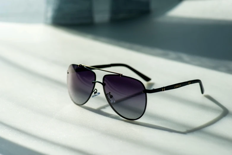 a pair of sunglasses sits on the surface