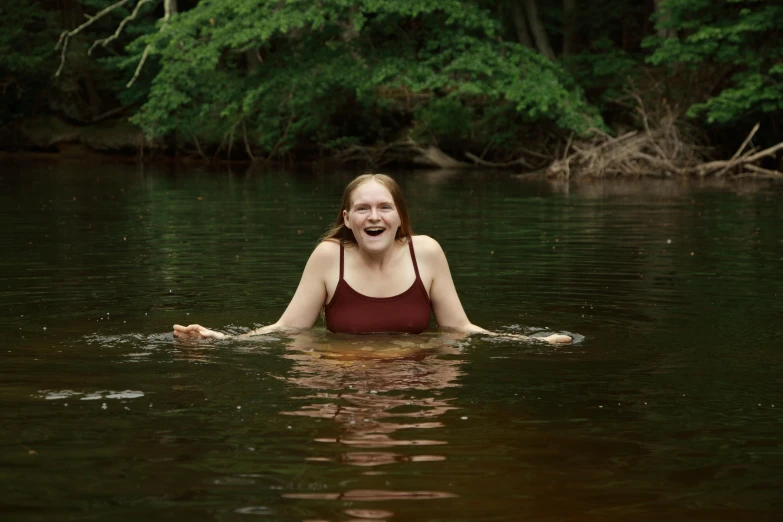 the young woman is swimming in the water