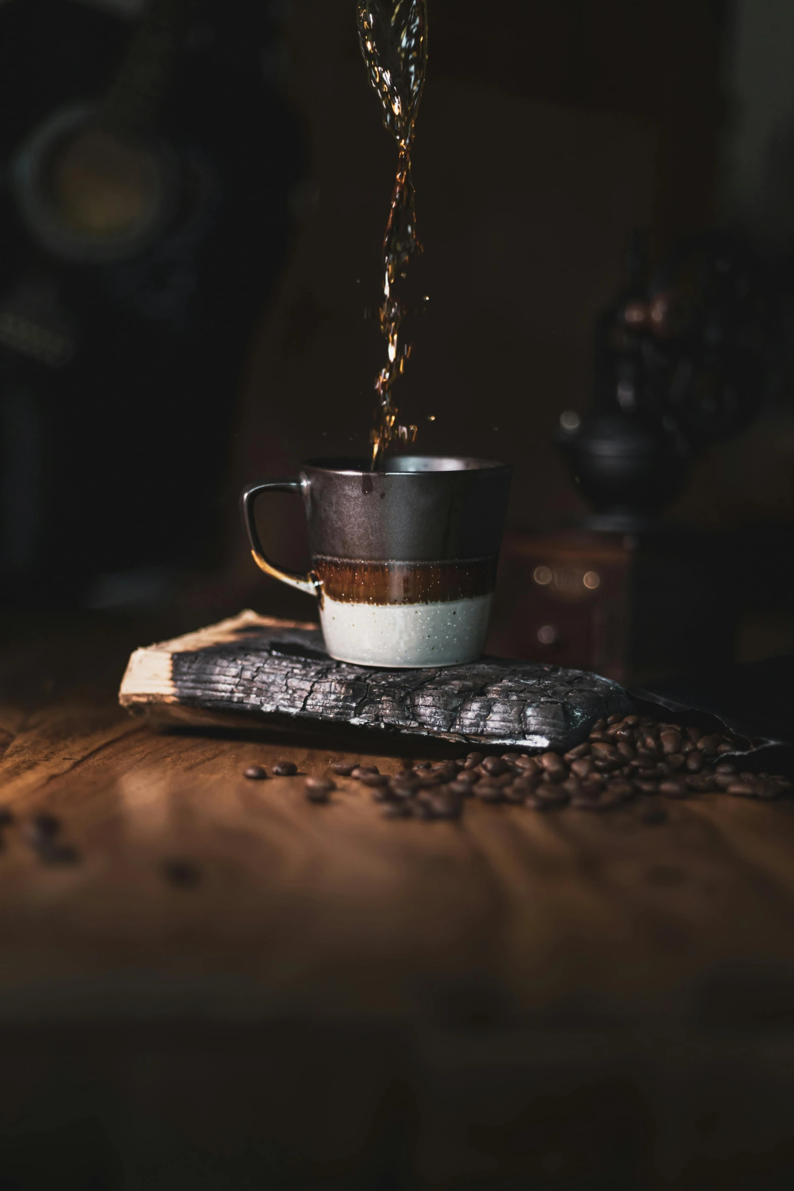 the coffee is falling into the cup and is still in its place