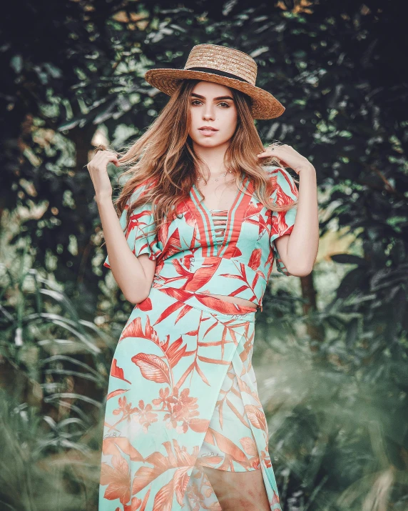 a woman in a dress and hat holding a handbag