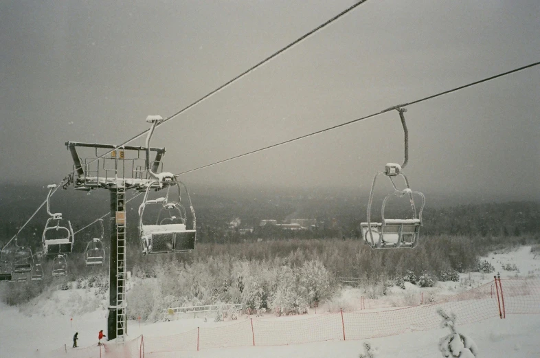 two ski lift cars ride down the hill