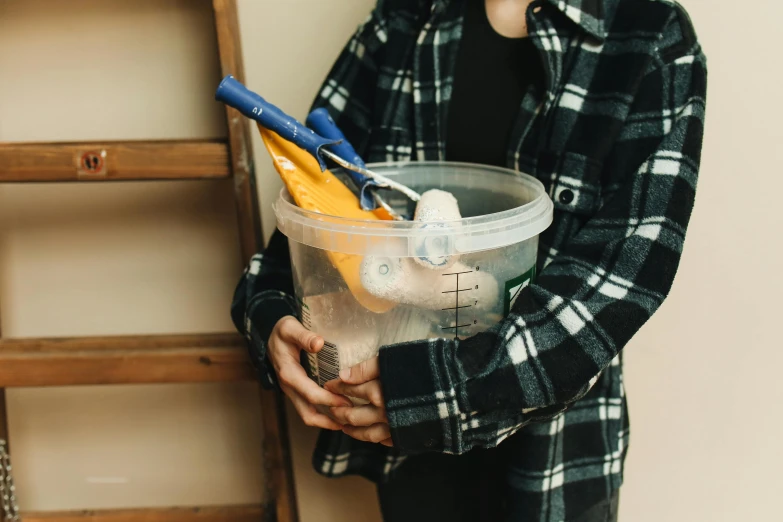 a person holding a container with various items inside it