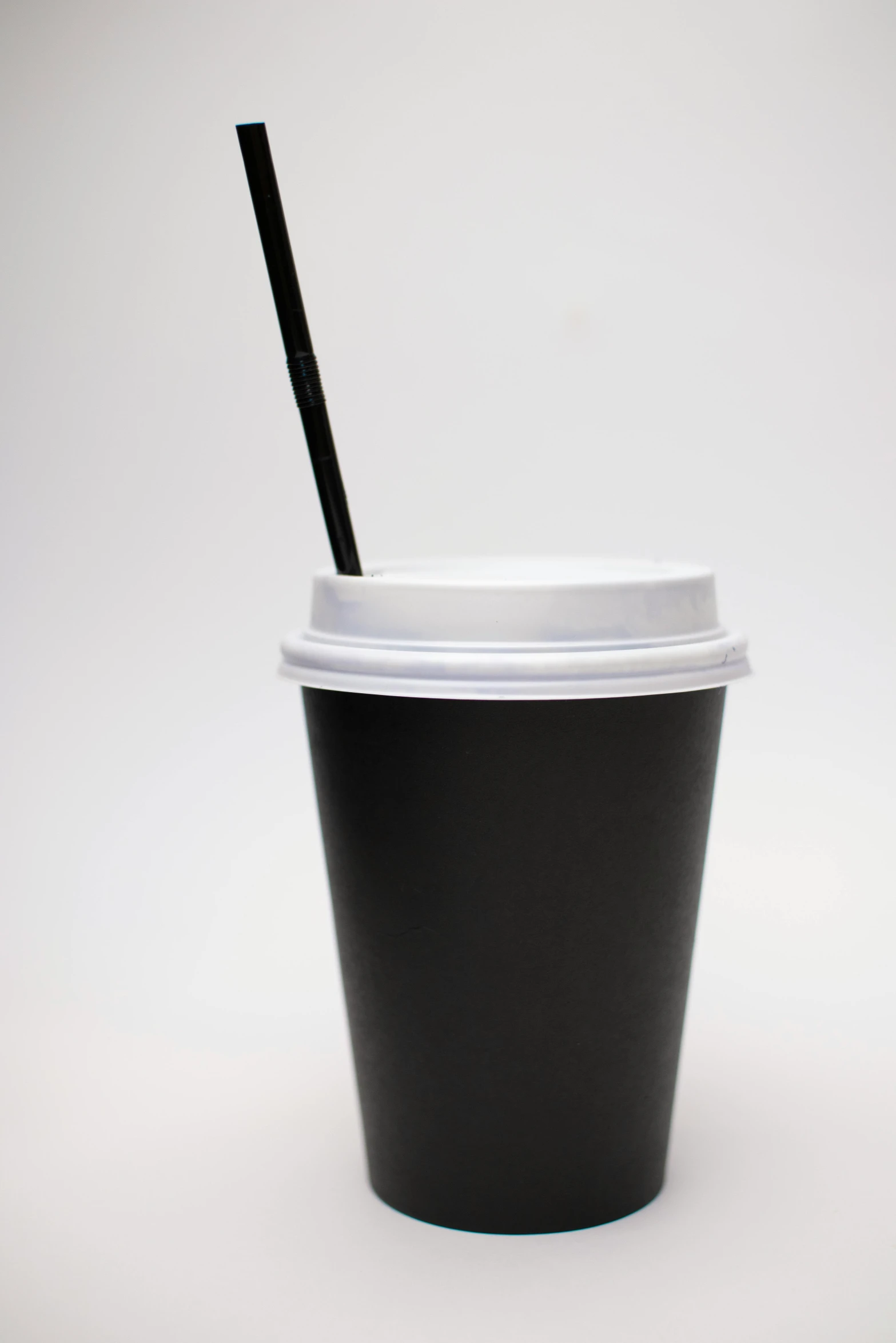 a cup with a lid and a black straw sticking out of it