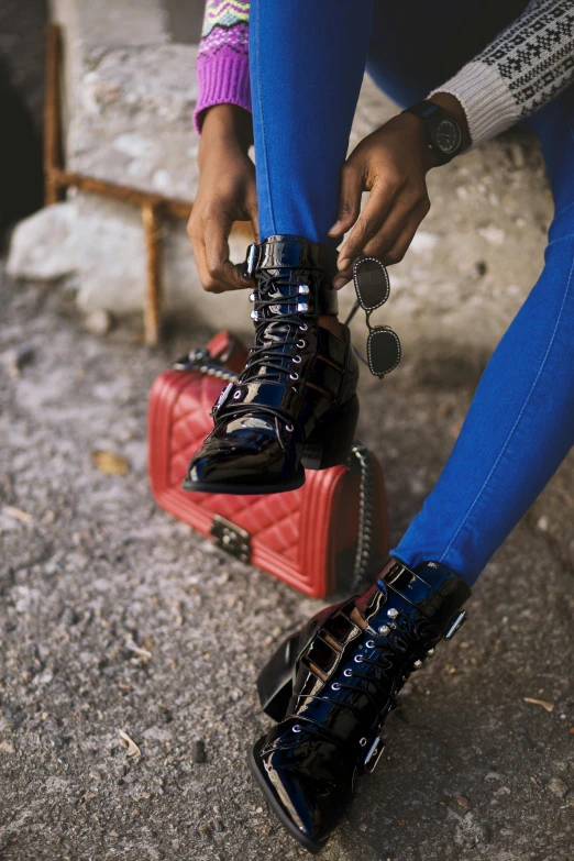 woman's legs and boots on luggage with the handles extended