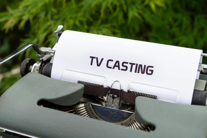 an old fashioned typewriter with a paper that says tv casting