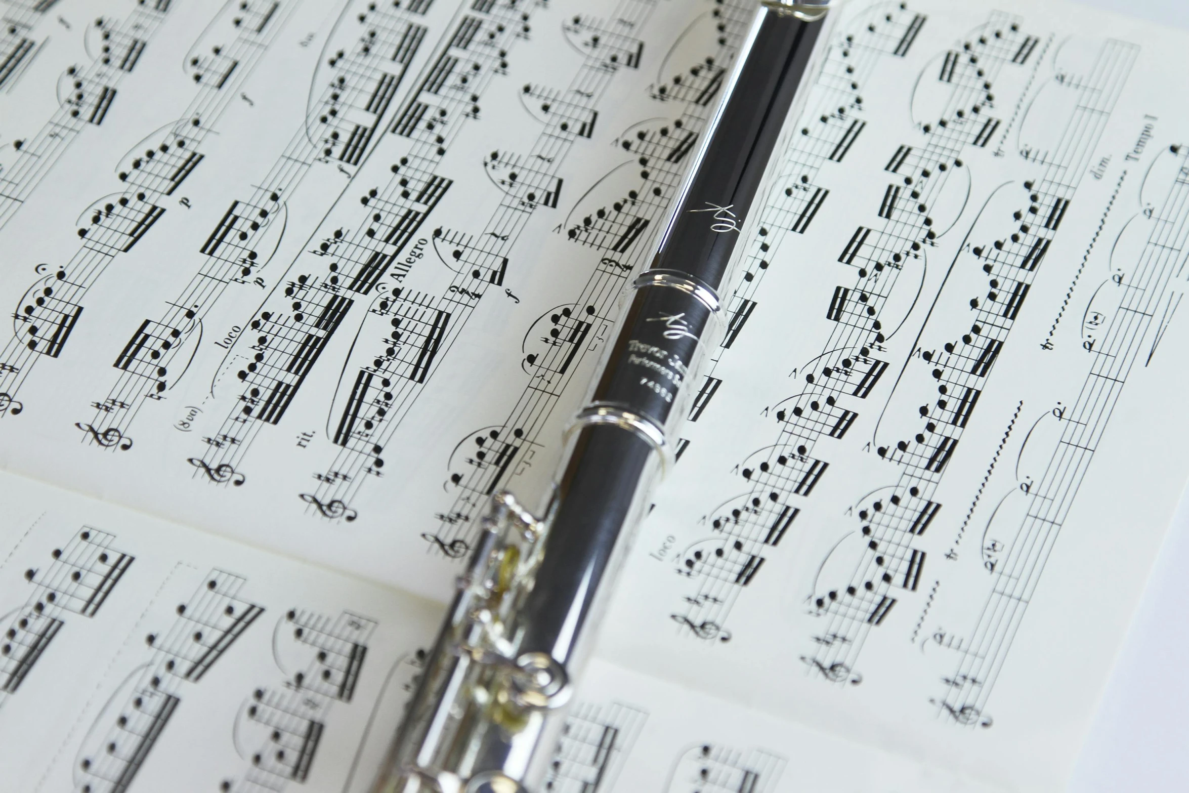 a pen sitting on top of music sheets