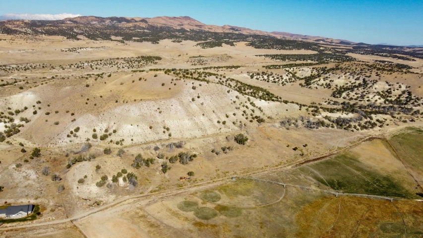 an aerial view of a mountainous area with some houses