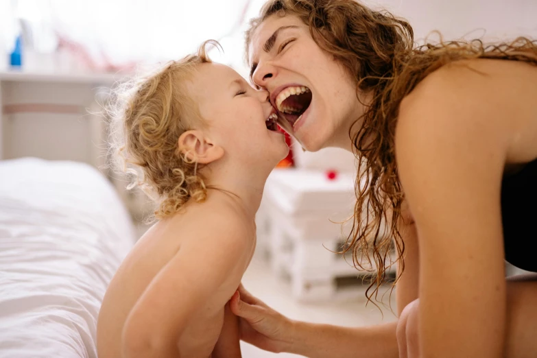 mother and child share an important moment on the bed