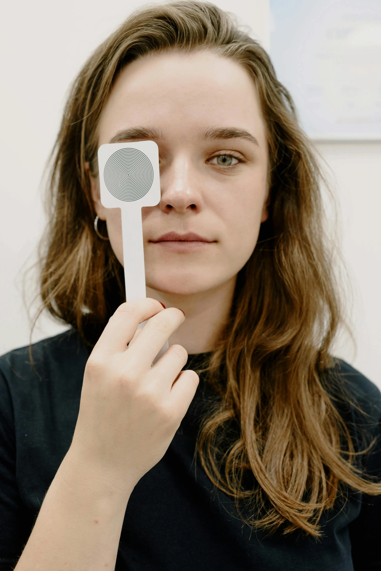 a girl holding an electric toothbrush and brush in her hand