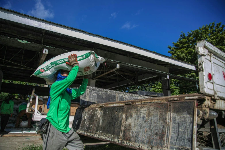 a man carrying some large pieces of cardboard