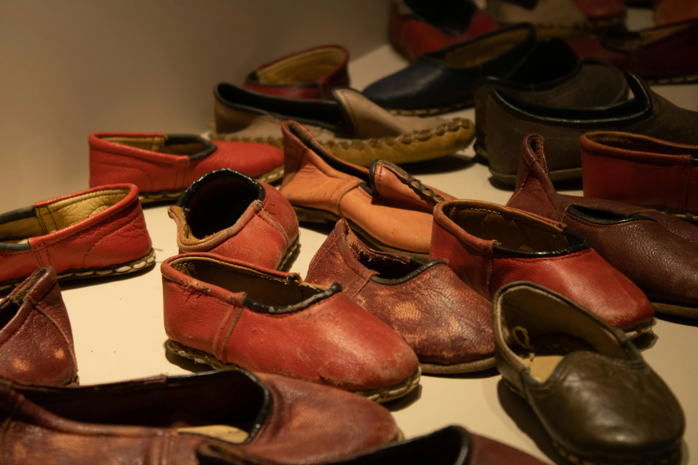 a bunch of old shoes are laying on the floor