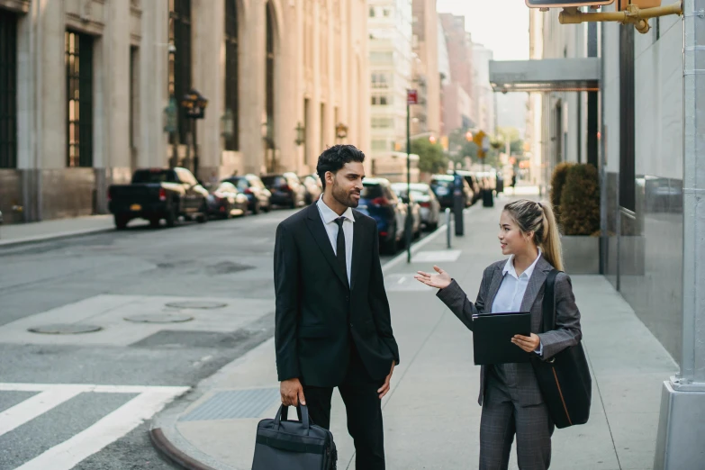 two people are talking at an intersection outside