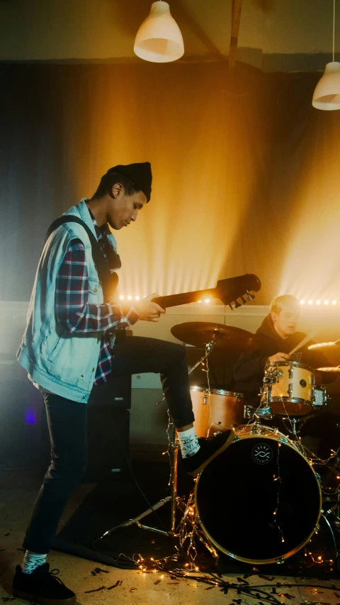 the young man is playing his electronic device while singing